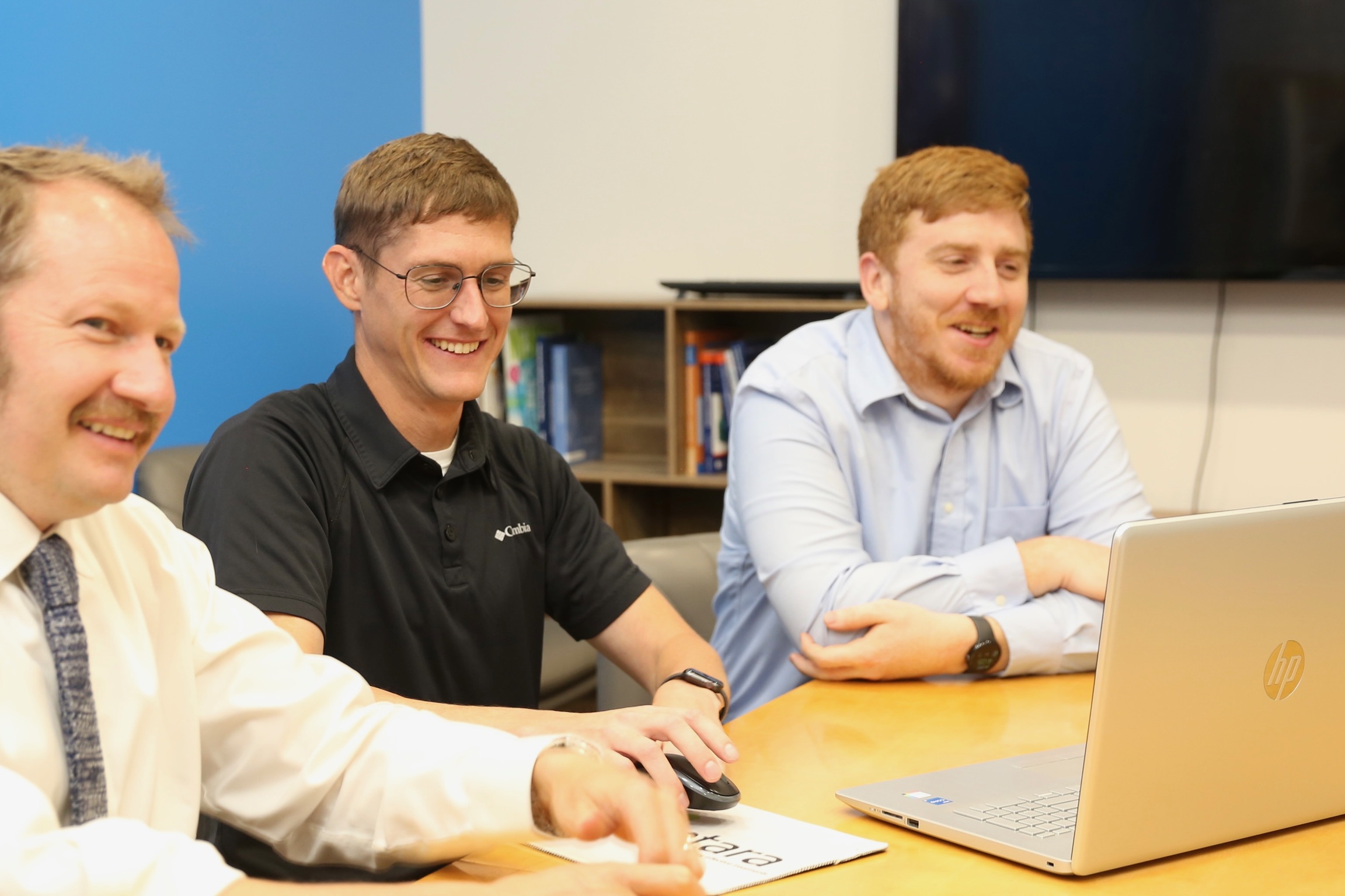 employees working around laptop